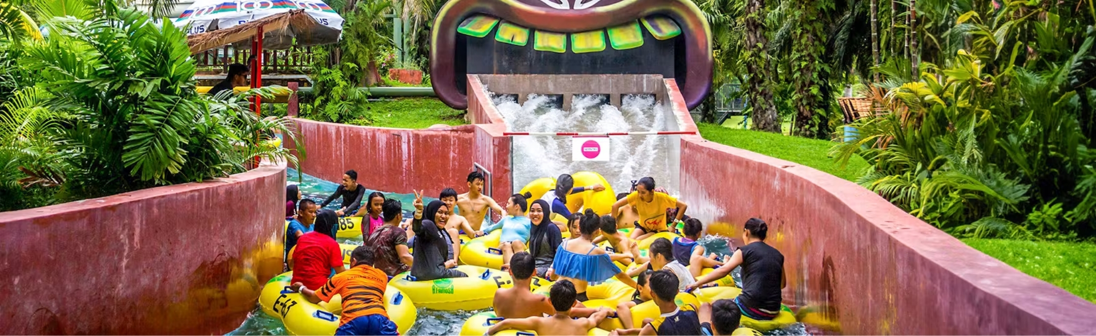 Families ride tsunami-style waves down the tribal-themed WAHAHA slide at A'Famosa Water World in Malacca, Malaysia.