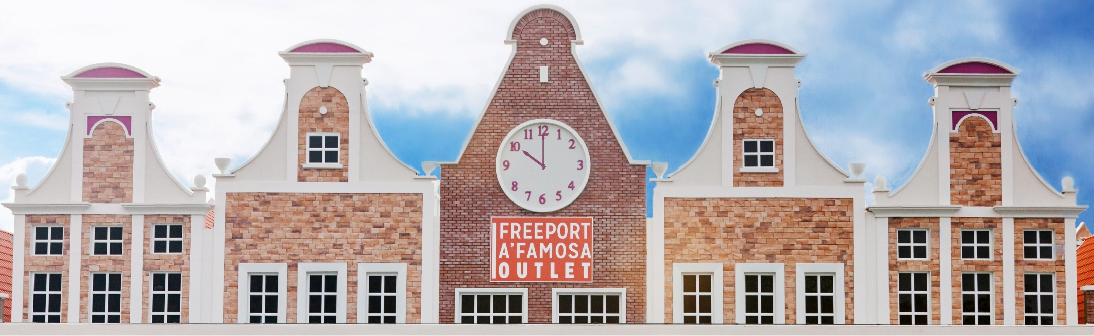 Dutch gable facades and a central clock greet shoppers at Freeport A'Famosa Outlet in Alor Gajah, Malacca, Malaysia.